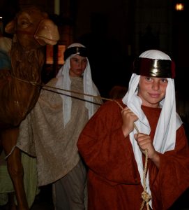 Boy Shepherds in costume arrive with a camel.